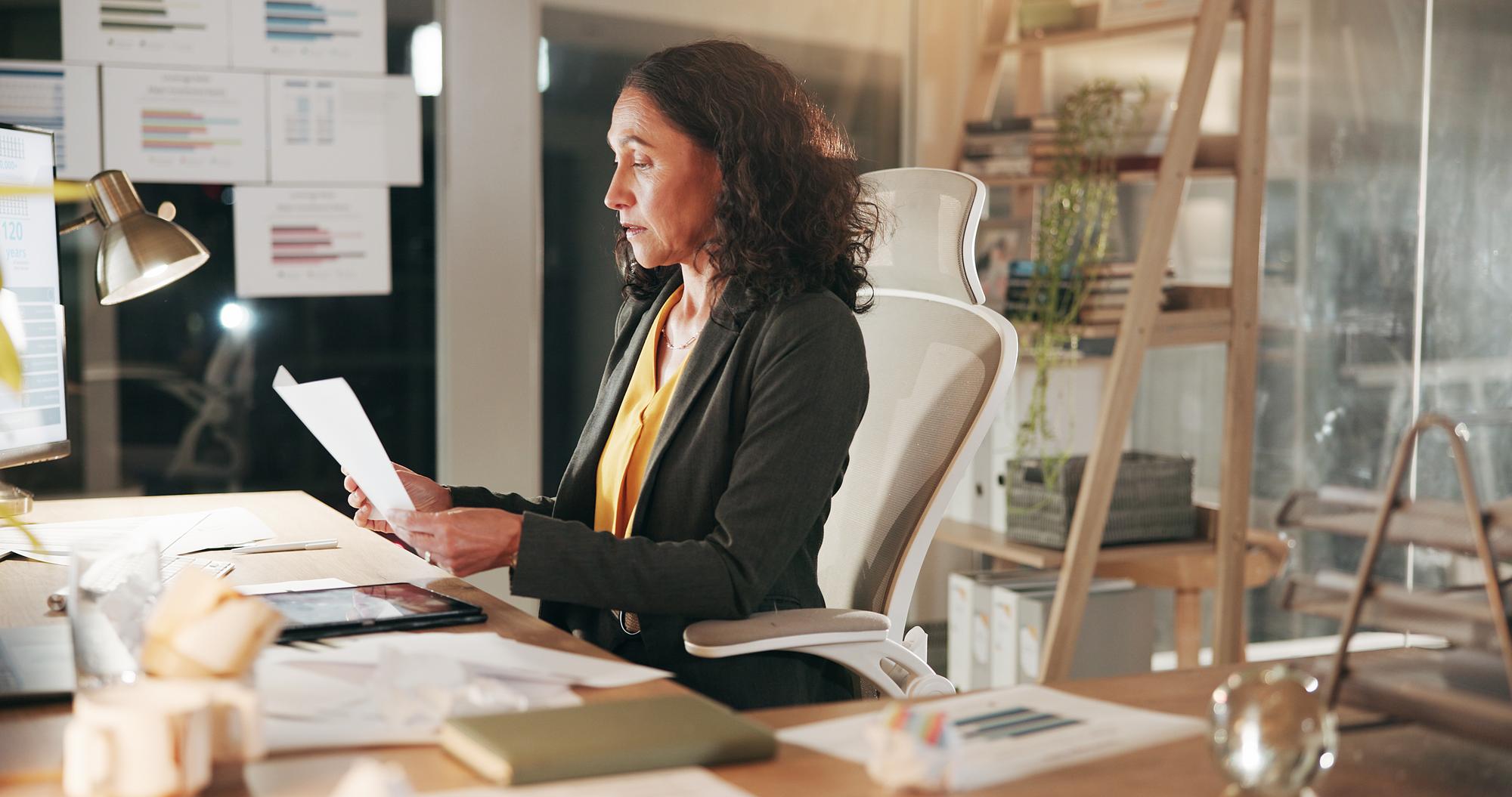 elegant person reviewing finances at desk
